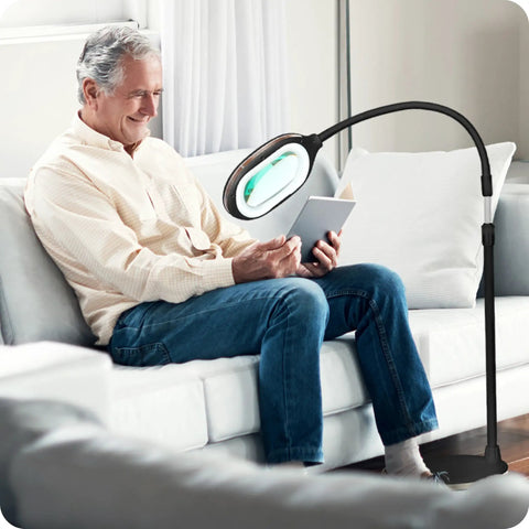 Man reading with LightView Pro Magnifying LED Desk Lamp with flexible gooseneck and 3 in 1 magnifier for eye comfort.