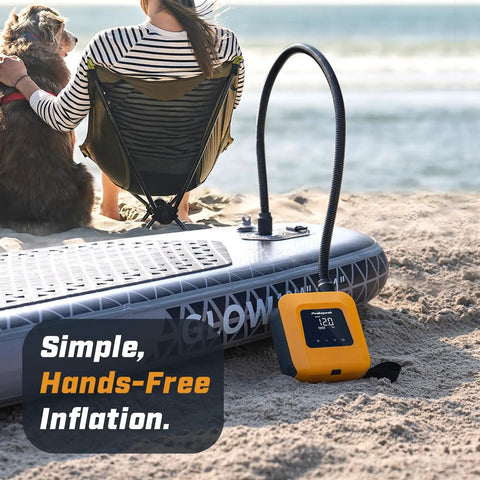 20 PSI Electric Paddle Board Pump S1 Portable SUP Air Pump on beach beside inflated paddle board, ocean in background
