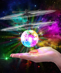 Indoor Hand Operated Flying Orb Ball Toy For Kids With LED Lights Remote Control Mini UFO Drone floating above a hand.