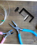 Two Pack Adjustable Outdoor Furniture Clips Sturdy No Slip Fasteners for Wicker Sofas and Chairs shown with pliers and wire