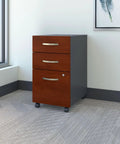 Series C 3 Drawer Mobile File Cabinet In Hansen Cherry For Home Office Organization And Commercial Workspaces placed near a window