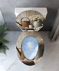 Elongated Toilet Seat Farmhouse design with rustic watering can and flowers on a wood background, top view.