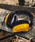 Adjustable Yellow Noise Blocking Ear Defenders For Shooting And Industrial Jobs With Slap Up Soundproof Earmuffs For Studying Ranges And Everyday Hearing Protection displayed on a wooden surface.