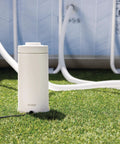 Powerful Cartridge Filter Pump for Above Ground Pools: Delivers 530 GPH Flow Rate with Built-in Auto Timer, shown on grass near pool