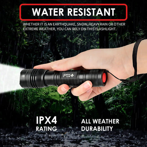 LED Tactical Flashlight PTAC1000 Two Pack With One Mode Operation, hand holding zoomable beam in rainy forest