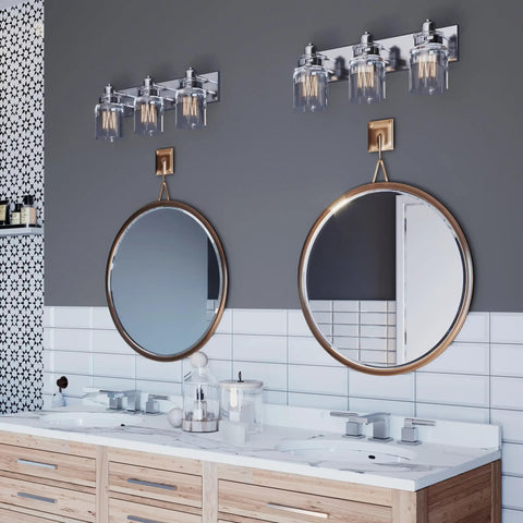 Calhoun Collection Clear Glass Farmhouse Bath Vanity Light Three Light Brushed Nickel Vintage Inspired Fixture on wall above vanity.