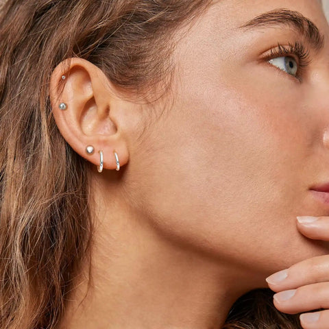 Surgical Steel Earrings Set For Multiple Piercings Nine Pairs Featuring Hoops CZ Studs And Ball Studs For Women Hypoallergenic 20G Dope Everyday Wear Must Have Jewelry With Three Styles And Sizes, model wearing small hoop and stud earrings