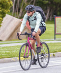 Cyclist on a pink road bike in a park setting