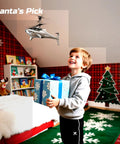 Child holding a wrapped gift with Shark Themed RC Helicopter For Kids And Adults With Altitude Hold One Key Takeoff in bedroom.