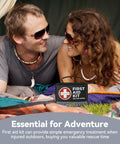 Couple in a tent with Compact 150 Piece First Aid Kit With Instant Cold Pack And Emergency Blanket for adventure travel.