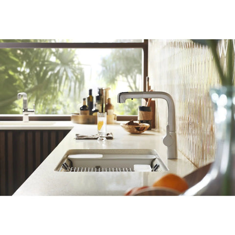 Riverby White Rinsing Colander With Built In Cutting Board on modern kitchen sink, showcasing sleek durable design.