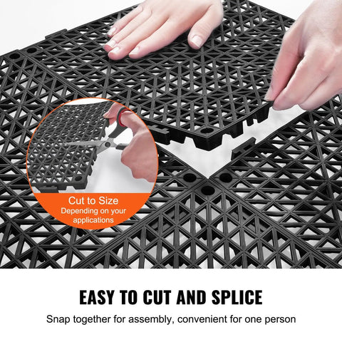 Interlocking Drainage Floor Tiles 50 Piece Set Black 12 By 12 Inch Soft PVC Mats With Non Slip Drain Holes For Restrooms shown being cut
