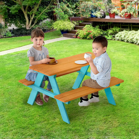 Two children sitting at Wooden Outdoor Kids Picnic Table And Bench Set In Brown And Aqua, on lawn, enjoying snacks.