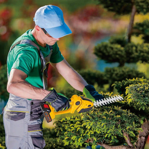Man using Easy To Use Cordless Hedge Trimmer with Battery and Charger 21V 2 In 1 Grass and Shrub Cutter on bush