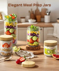 4 Pack 10oz Glass Meal Prep Jars With Bamboo Lids on kitchen counter filled with salads, yogurt, and fruit