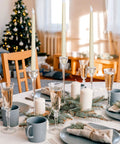 36 Piece Flameless Taper Candles Set With Flickering LED Light setup on a festive holiday table with Christmas decor.