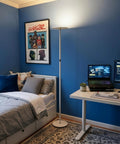 Sky LED Floor Lamp Torchiere Lit And Super Bright Dimmable Tall Standing Lamp in a blue bedroom with desk and computer setup.