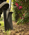 Person using round point shovel from Three-Piece Small Spaces Gardening Kit With Border Spade, Digging Fork, And Round Point Shovel.