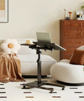 Overbed Table With Wheels Adjustable Height 23 to 33 Inches, Rolling Laptop Desk With Tilting Top, beside a sofa in home setting