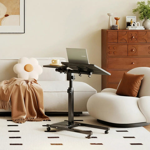 Overbed Table With Wheels Adjustable Height 23 to 33 Inches, Rolling Laptop Desk With Tilting Top, beside a sofa in home setting
