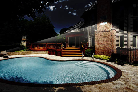 Illuminated house and pool using Solar Powered AI Smart Motion Dual Head LED Flood Light 10W 1200 Lumens Outdoor Security Glow No Fuss.