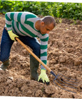 Man using Heavy Duty Iron Manure Fork For Household Use And Lawn Cleanup Multi Functional Grass Fork For Quick Yard Work
