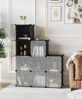 Cube Storage Organizer With Doors, 9 Cube Modular Shelves Closet Cabinet in a living room, modern black finish, holding decor items.