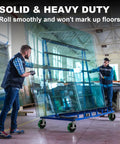 Two workers using Badass Heavy Duty 8 Inch Caster Wheels 2 Pack Polyurethane Tread On Cast Iron Core to move glass sheets.