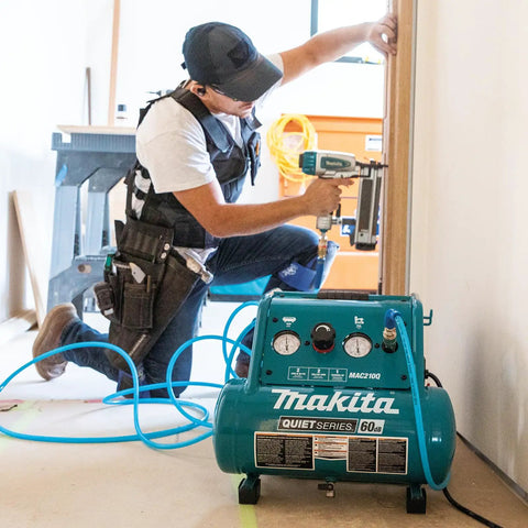 Kickass Quiet Electric Air Compressor, 1 Horsepower 2 Gallon Tank, used by contractor with nail gun in job site.