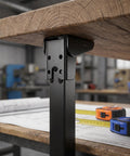 Close-up view of 2 Pack Heavy Duty Folding Table Legs Made Of Metal With Self Locking Mechanism under a workbench, stable black finish.