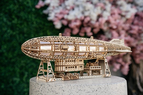 Luminous Zeppelin LED 3D Wooden Puzzle Kit For Adults displayed on stand with intricate details, airship shape visible.