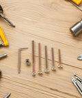 49 Piece M6 X 40-80mm Hex Socket Furniture Screw And Barrel Nut Set for bed frame repair with tools on wooden surface