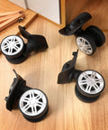 4 Pcs Universal Suitcase Wheel Replacement Set Heavy Duty Luggage Casters Quiet Dual Row Design Black shown on wood surface