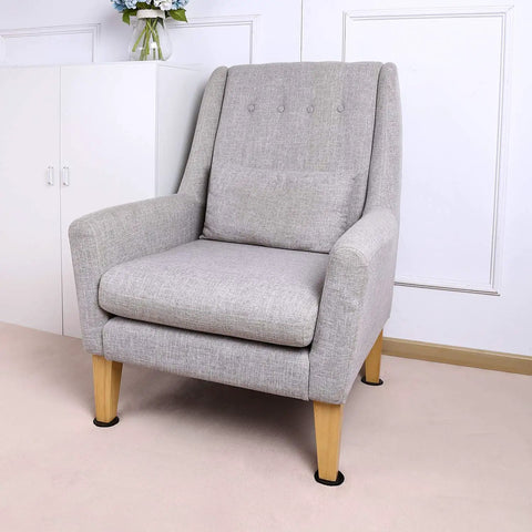 Gray armchair with wooden legs on carpet, featuring 40 Pack 1-1/8 Inch Self-Stick Round Carpet Furniture Sliders Heavy Duty Self-Adhesive Moving Pads For Carpet Chair Glides For Sofas And Tables Black Easy To Use.