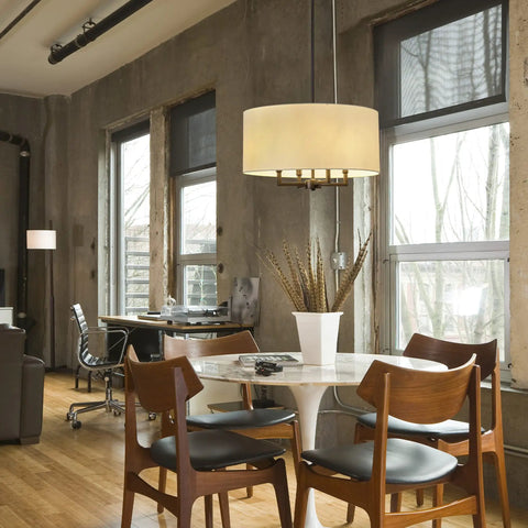 Four Light Matte Black Chandelier With Beige Fabric Shade hanging over dining table in modern farmhouse setting