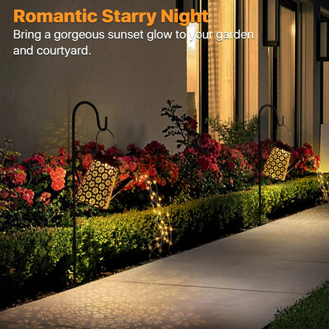 Solar Powered Watering Can Lantern Lights For Garden Decor illuminating a pathway at night in a garden setting.