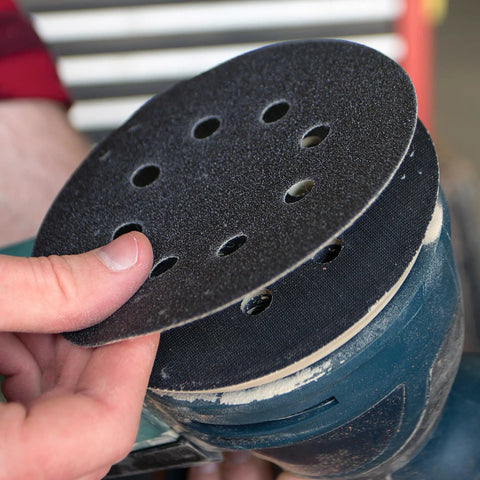 Gator Auto Hook And Loop Ceramic Sanding Discs With Quick Change System for 180 grit blending, being attached to a sander.