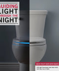 Sanborne Round Nightlight Toilet Seat With Slow Close and Quick Release glowing in a dark bathroom for nighttime use.