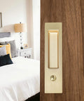 Privacy Pocket Door Lock With Key And Handle, 7 Inch Brushed Gold Invisible Rectangular Edge Pull, shown installed on bedroom door.