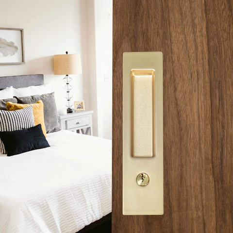 Privacy Pocket Door Lock With Key And Handle, 7 Inch Brushed Gold Invisible Rectangular Edge Pull, shown installed on bedroom door.