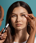 Close-up of a woman applying Super Strong Black Lash Glue For Strip Lashes And Clusters With Biotin And Blueberry Extract Gentle On Natural Lashes