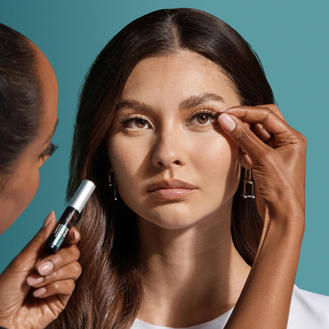 Close-up of a woman applying Super Strong Black Lash Glue For Strip Lashes And Clusters With Biotin And Blueberry Extract Gentle On Natural Lashes