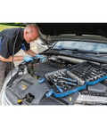 Mechanic using Six Point Socket Set With One Quarter Inch, Three Eighths Inch And One Half Inch Square Drive Metric Tool Kit In Blue Case Includes Seventy Two Tooth Reversible Ratchet And Chrome Vanadium Sockets With Satin Finish on car engine