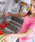 Woman using Heavy Duty Stainless Steel Sink Grids 13 5/8 By 11 5/8 Inches, 2 Pack Center Drain Hole Rust Resistant Kitchen Sink Protectors