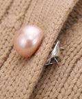 Close-up of 25Pcs No Sew Faux Pearl Brooch Pins Detachable Sweater Clips on a knit fabric for snug fit.