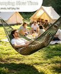 Person relaxing in Breathable Mesh Hammock With Nylon Net For Easy Setup Rope Style Hang Loose Outdoors 98 X 31.5 Inches 100 Kg Capacity Perfect For Camping Backyard Tree Hanging Olive Green near campsite with group in background.