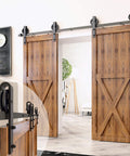 Beefy Black Rustic Sliding Barn Door Hardware Kit For Two Doors, 16 Foot Flat Track With Spoke Wheel Rollers installed indoors