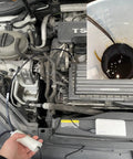 Hassle Free Grab And Go Portable Usb Oil Extractor Pump extracting dark oil from engine into a measuring container.