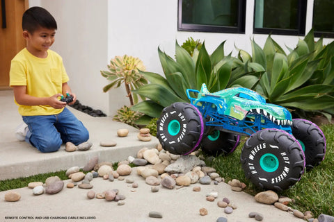 Child controlling Mega-Wrex 1 To 6 Scale RC Monster Truck with All Terrain Tires, showcasing rugged design and offroad capability.