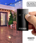Dual Outlet Outdoor Timer Switch With Wireless Remote For Yard Lights And Garden Decor No Sweat Scheduling Slick Plug In Convenience Top Shelf All Weather Construction in use with remote.